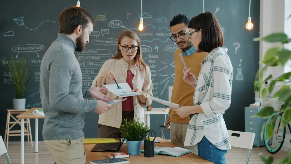 Colleagues sharing ideas around a table